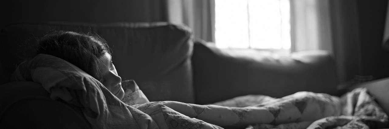 Clinical Depression: Extreme Tiredness & Fatigue Is the Worst Symptom girl lays on a couch