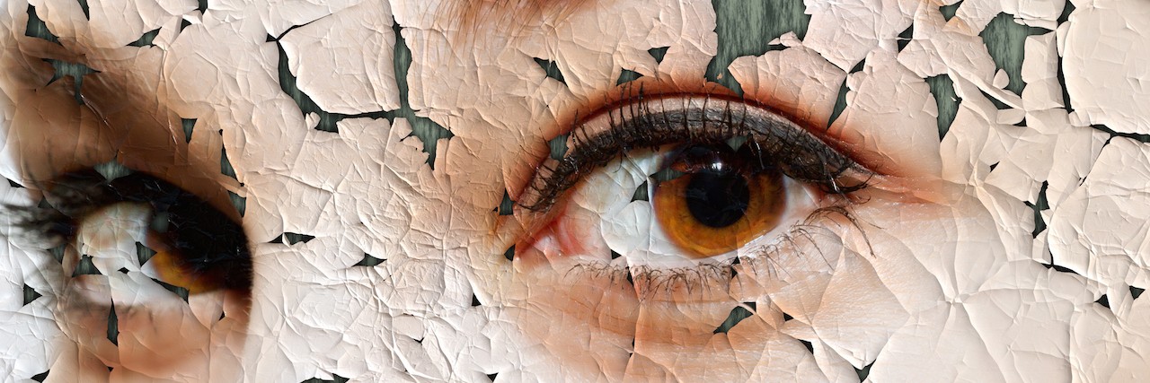 What It Means When Someone With Depression Says 'I'm Fine' cracked photo of a woman's eyes