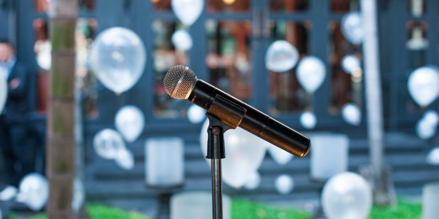 microphone on stand with wedding decorations in the background