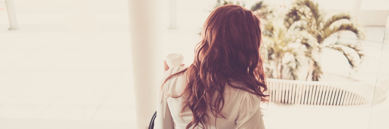 Nurse Says Patient Doesn't Look Like She Has Depression rear view of businesswoman going down the escalator