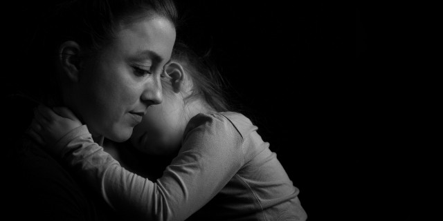 Mother and daughter hugging.