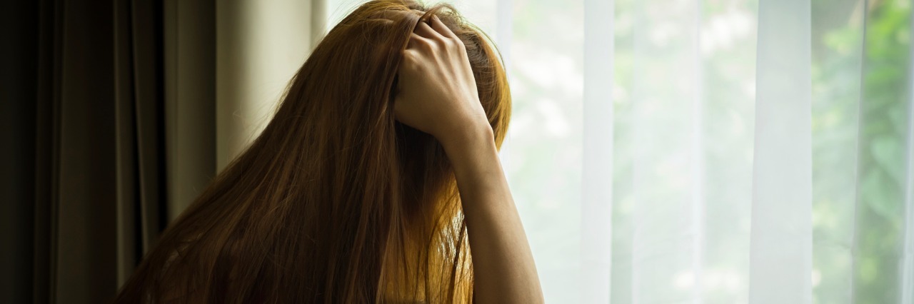 Sad girl looking out of window