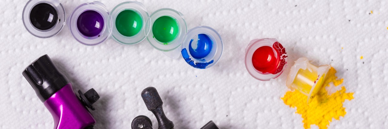 Why I’m Not Choosing a Puzzle Piece Tattoo to Represent My Autism Tattoo equipment and small containers of inks in different colors