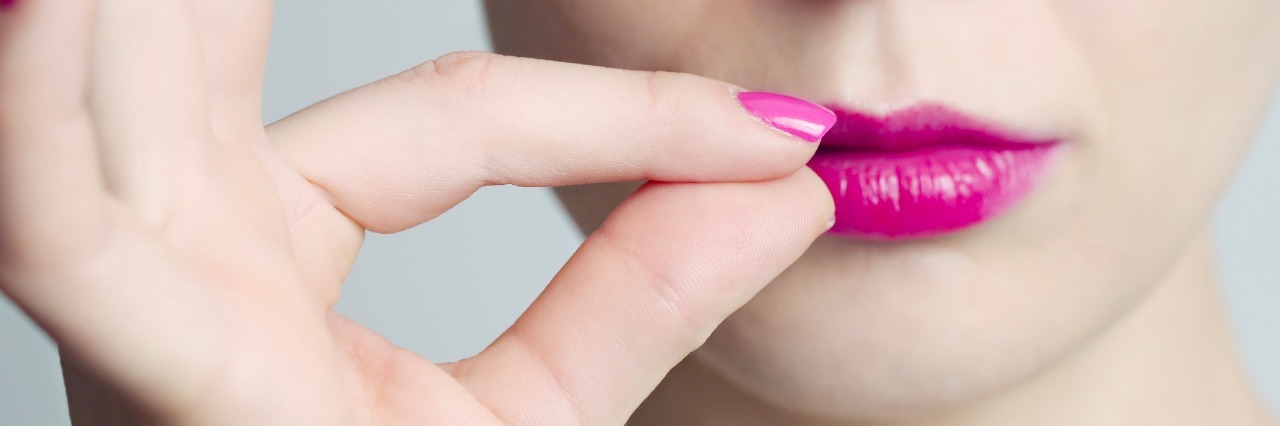 What It's Like to Have Hyperlexia woman zipping her lips shut with her fingers
