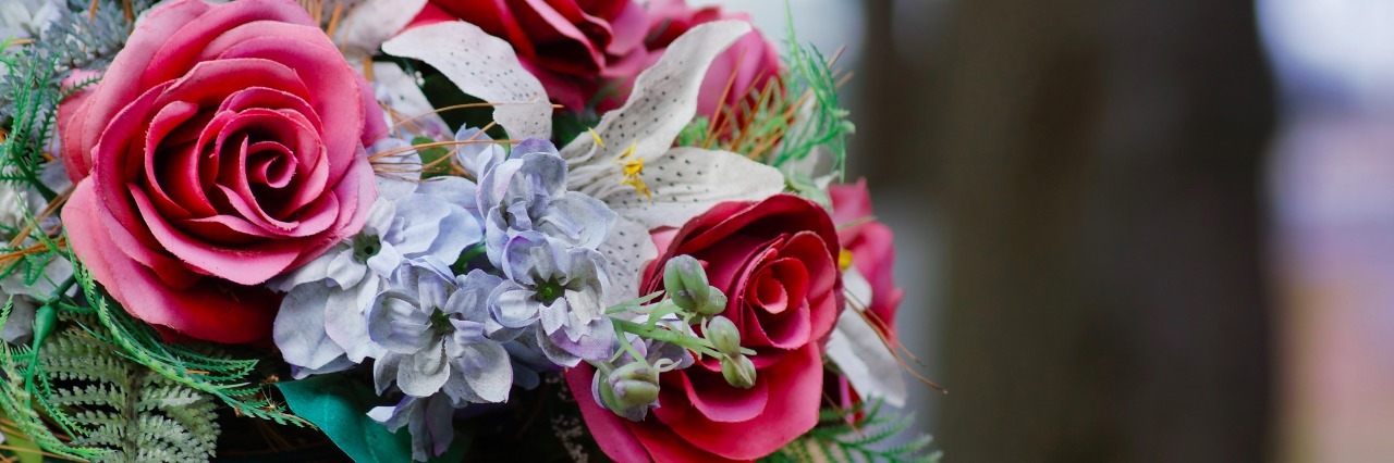 Language at Funeral Service Helps Ease Shame About Suicide bouquet of flowers on a gravestone