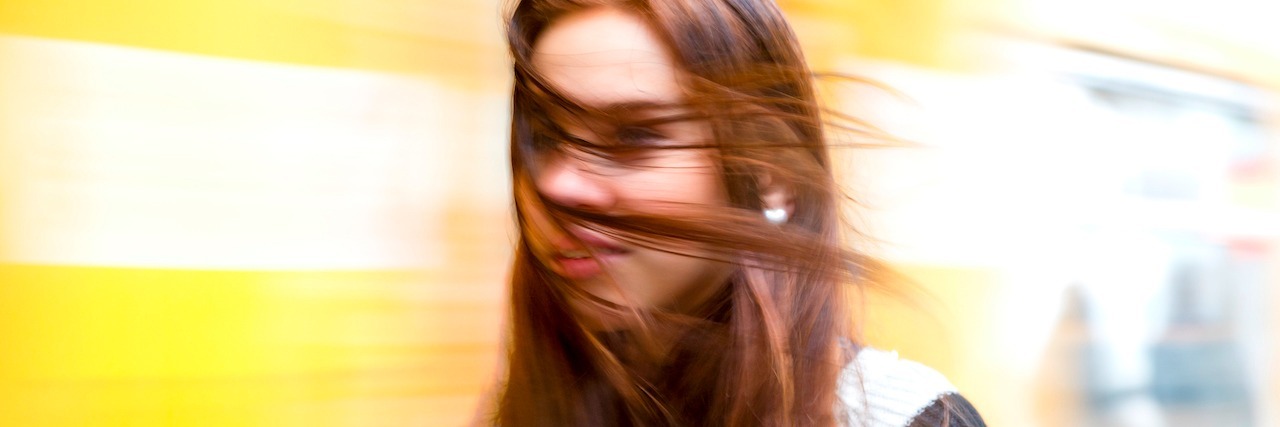 Mental Illness: When Trauma Makes You Forget Your Own Story woman with her hair being blown by the wind
