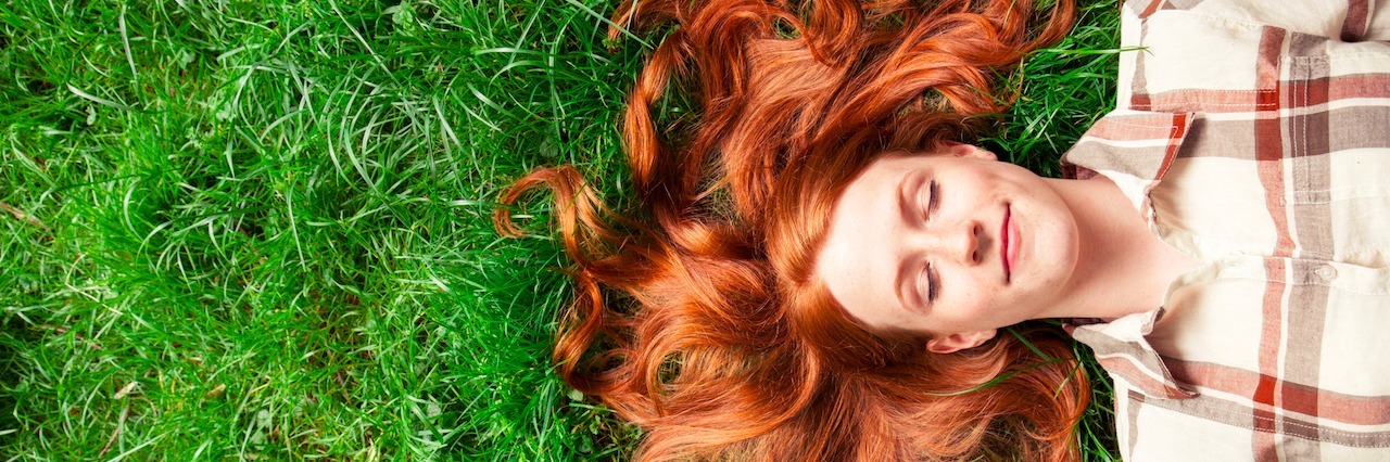 What It's Like to be Stable When You Have Bipolar Disorder woman laying in grass