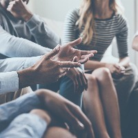 people sitting in a circle having a discussion