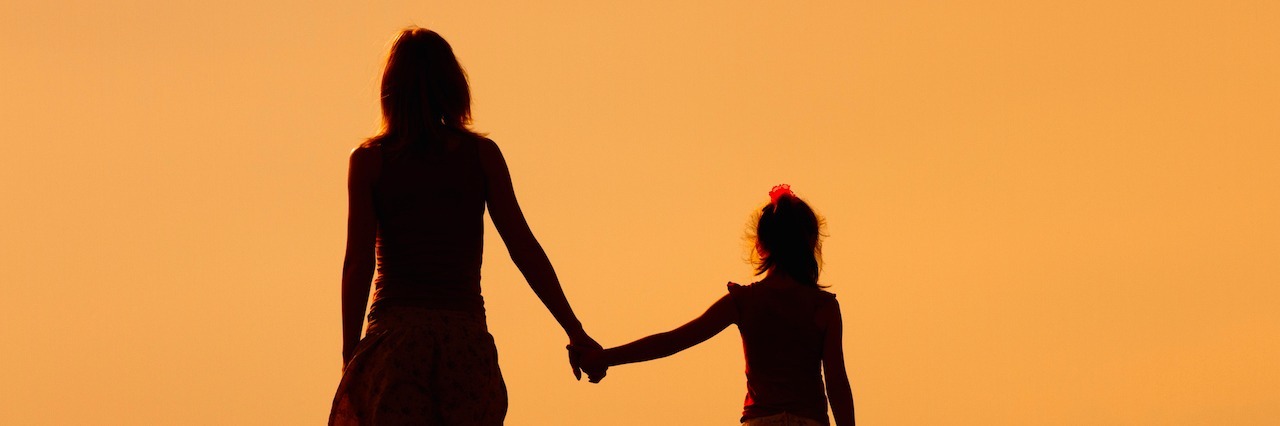 Working for Recovery When Your Daughter Is Battling Childhood Anorexia Silhouette of a woman holding hands with her daughter