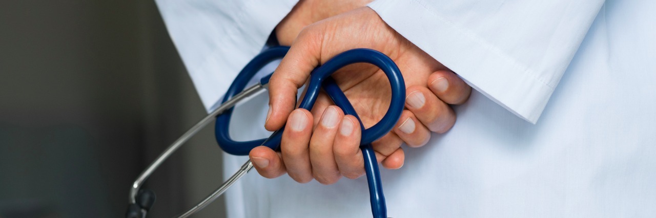 Close up of hands of doctor holding stethoscope in a hospital