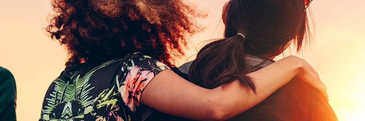 How My Friend Supported Me After My Pulmonary Regurgitation Diagosis Two women with arms around each other, looking at sunset