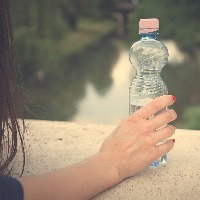 woman hand holding a bottled water, vintage view