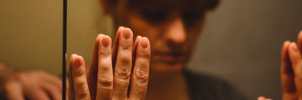 Eating Disorder: How to Respond When Friends Make Body Comments woman with her hands on a mirror, looking at her reflection