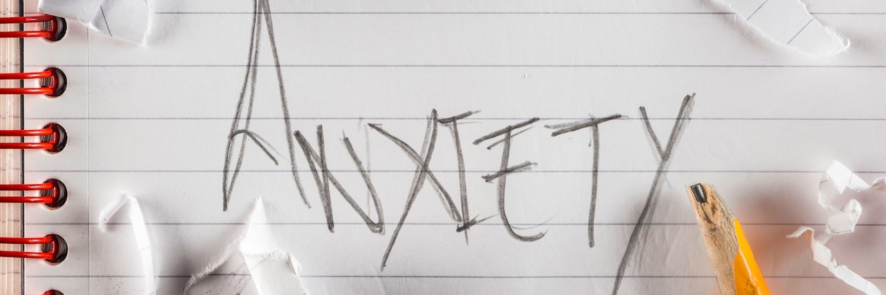 The word anxiety written in pencil surrounded by crumbled up pieces of paper