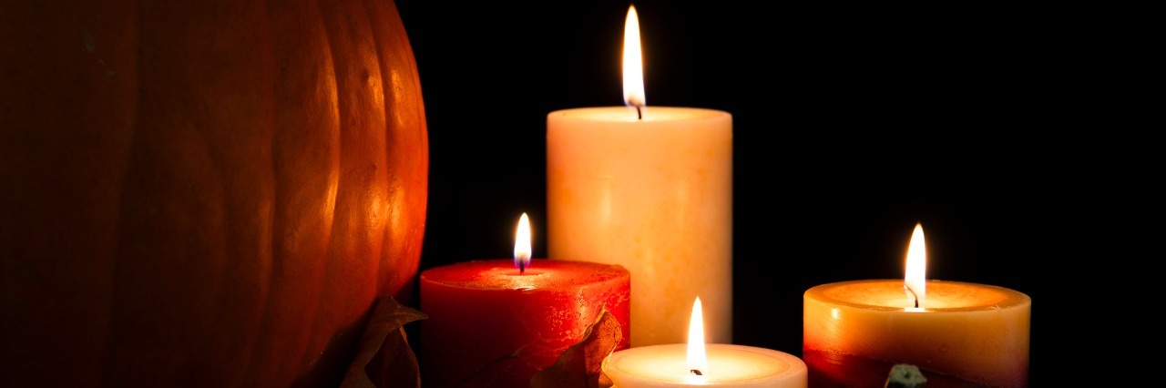 Suicide Loss: The First Thanksgiving Without My Daughter lit candles surrounded by pumpkins