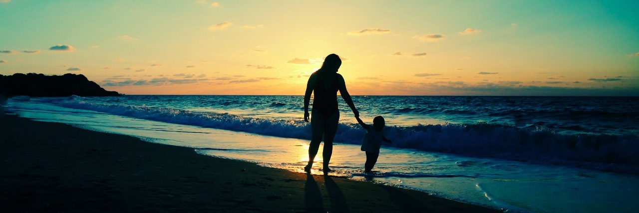 Mental Illness: Relative Doubts Mother's Love for Her Children mother and young daughter holding hands at the beach