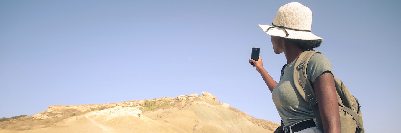 How I Found Hope in Life With Mental Illness A woman hiking on sand dunes
