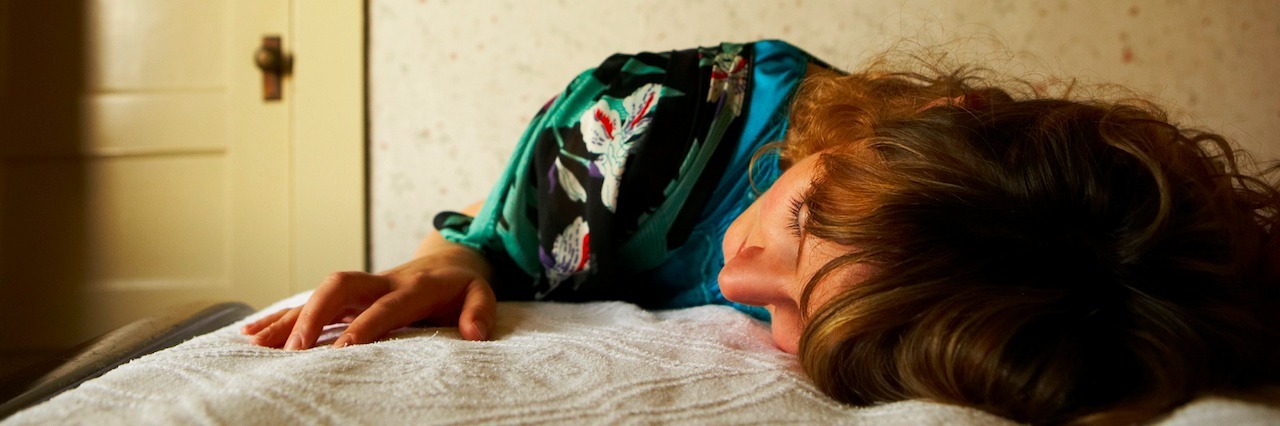 Young woman laying on bed