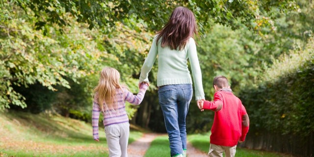 The People I'm Thankful for as a Special Needs Parent mother and two children walking on woodland path in autumn