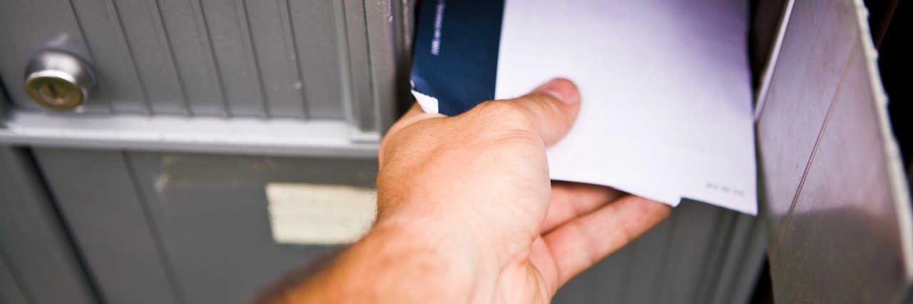 Social Anxiety Symptoms a Man With Anxiety Experiences in Public Man reaching his hand to get mail at the post office