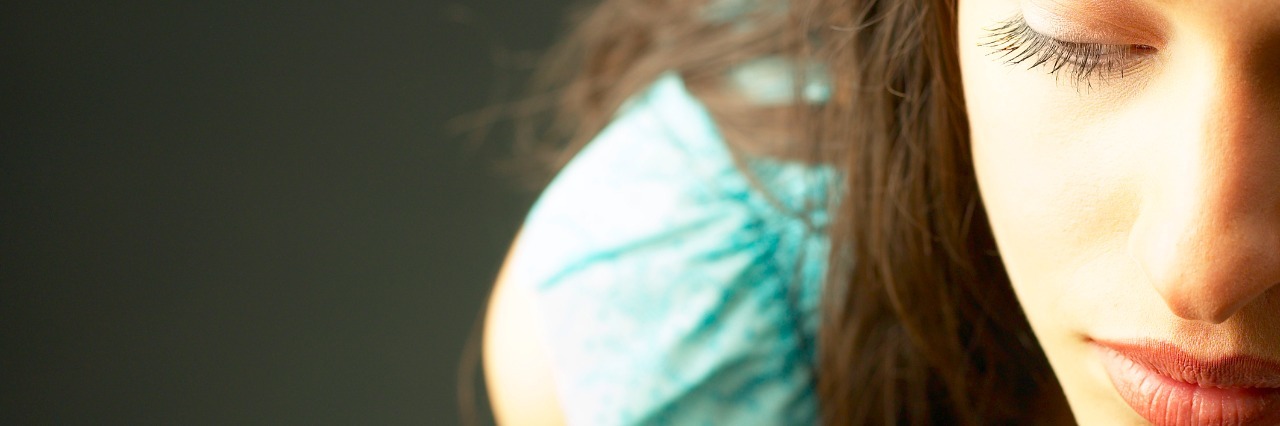 The Difference Between Having an Anxiety Disorder and Feeling Anxious close up of young woman looking downwards