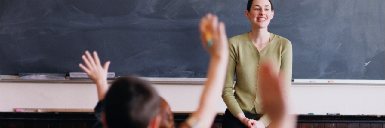 What I Want Teachers to Know About My Son on the Autism Spectrum Teacher in Front of a Classroom