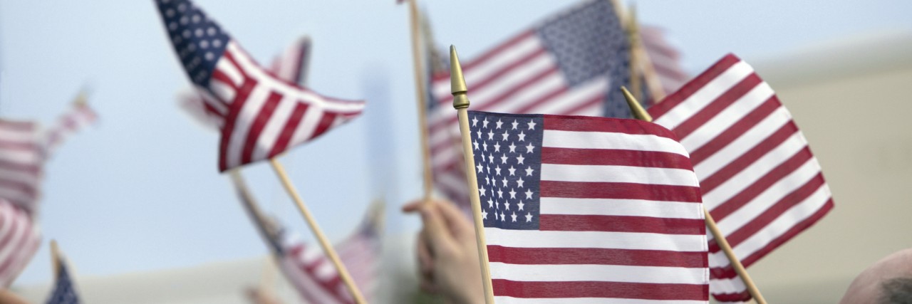 After the Election, What Is Future of Healthcare Under Trump? Crowd Waving Stars and Stripes Flags