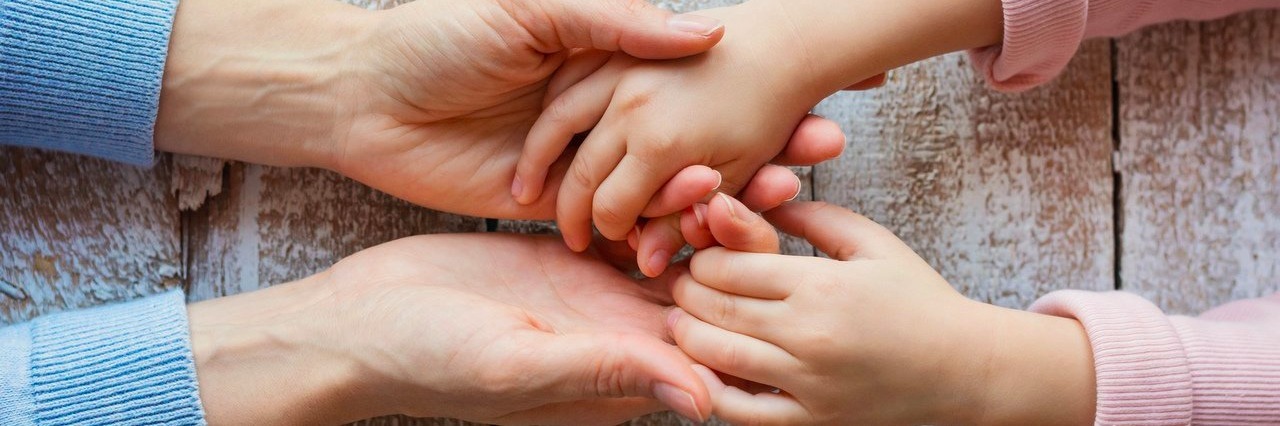 How to Support a Person in Pain mother and daughter holding hands
