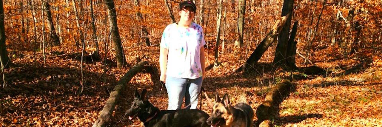 Explaining Hemiplegic Migraines and PTSD to Friends and Family woman walking dogs in woods