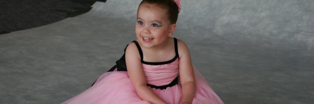 little girl with cerebral palsy in a ballerina costume