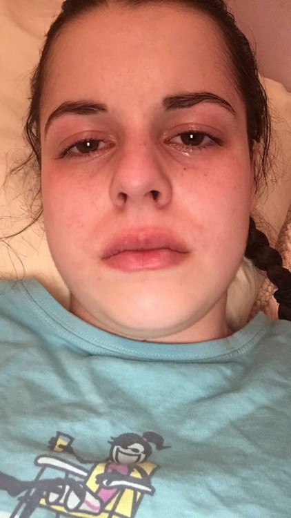 girl lying on bed looking up with tears in her eyes
