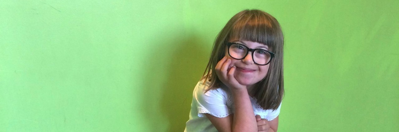 Down Syndrome Awareness: Please Accept My Children as They Are young girl sitting in the corner of a green room