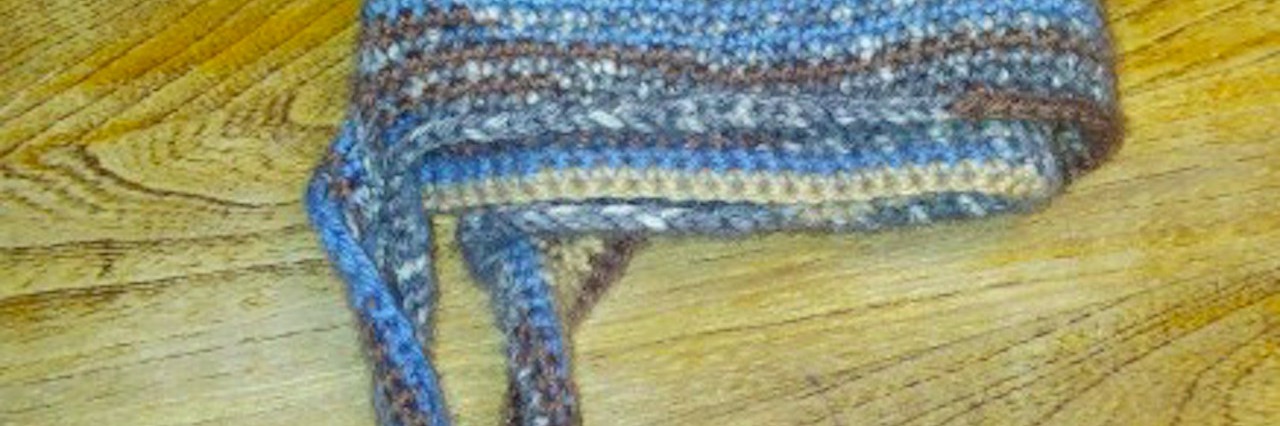 Gift Helps 2 Families Through Grief a handmade hat sitting on a wooden desk