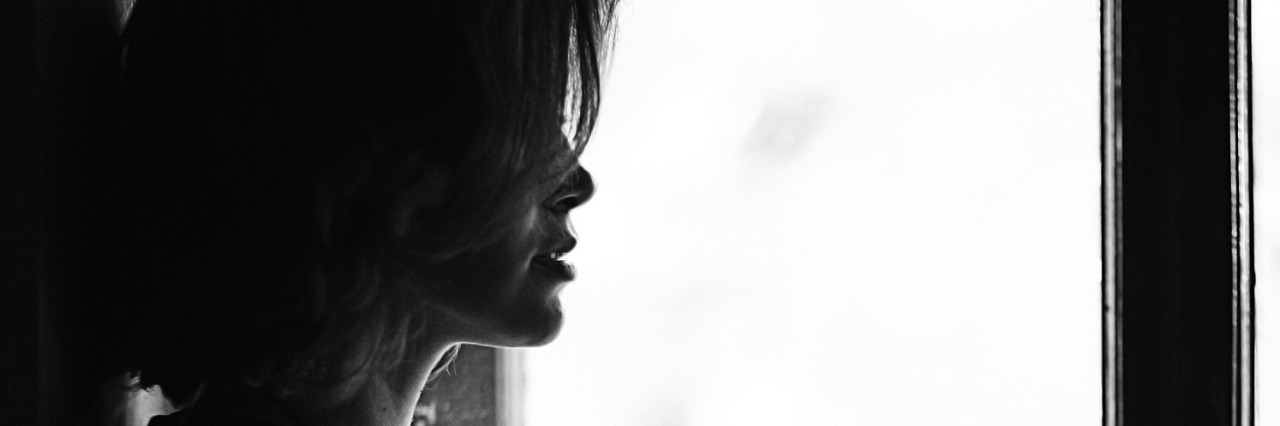 girl in the window monochrome portrait
