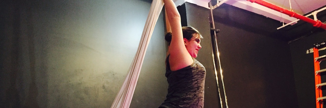 woman performing fabrics pose during dance class