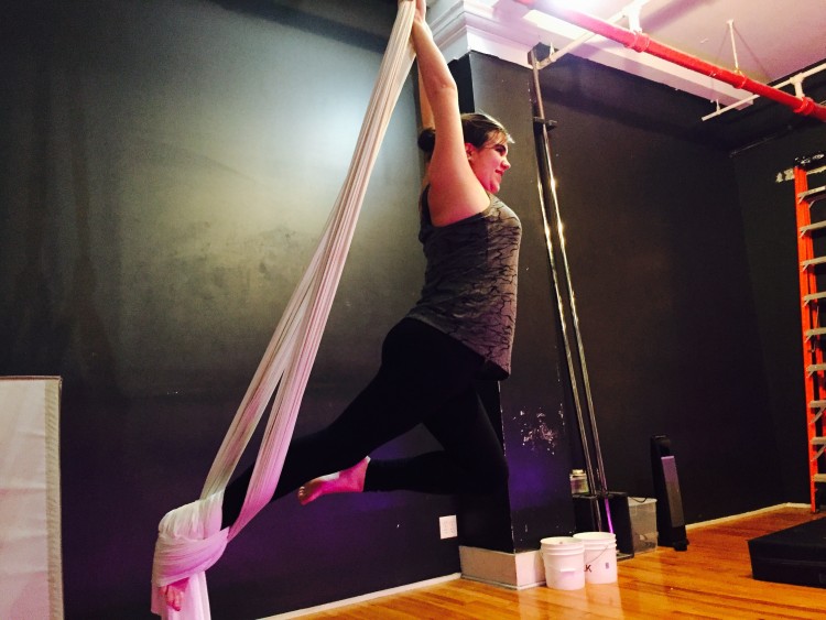 woman performing fabrics pose during dance class