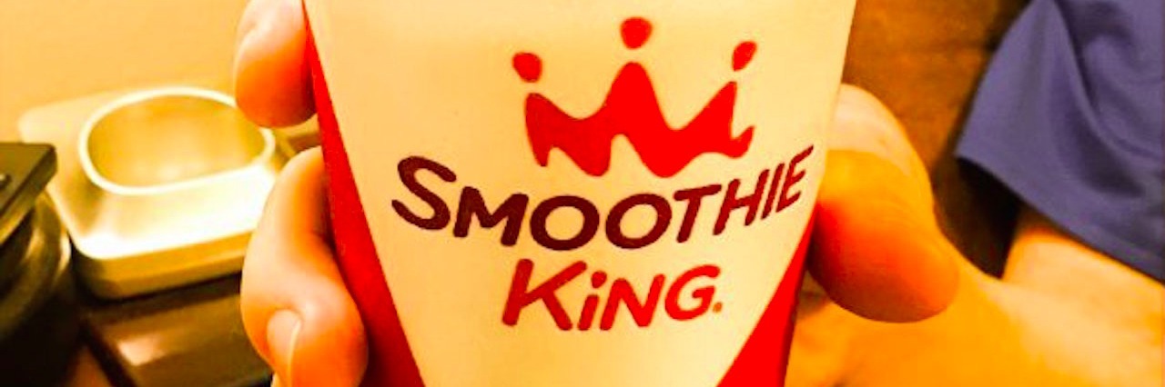 Chronic Illness: Advice on Offering Help to Families mans hand holding a styrofoam cup that says smoothie king