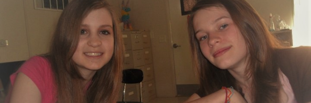 Being a Teen in High School With Undiagnosed Hashimoto's Thyroiditis two young girls sitting in a room and smiling at the camera