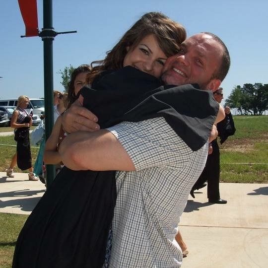 The author hugging his daughter at her graduation.