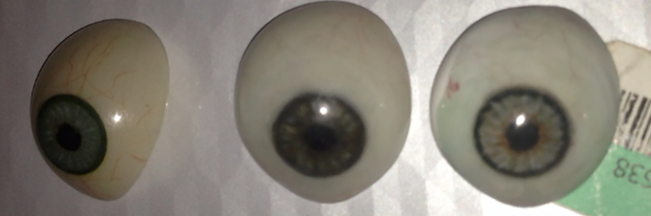 Accepting Myself as a Person With Micropthalmia and a Prosthetic Eye These are several examples of scleral shell eye prosthetics I have worn over the years. Each one costs over $3,000 so why wouldn’t I keep them. The left one was my second manufactured eye prosthetic that I wore throughout elementary school. The ones beside it and the one I wear now are handmade, and fit and look better than the manufactured eyes.