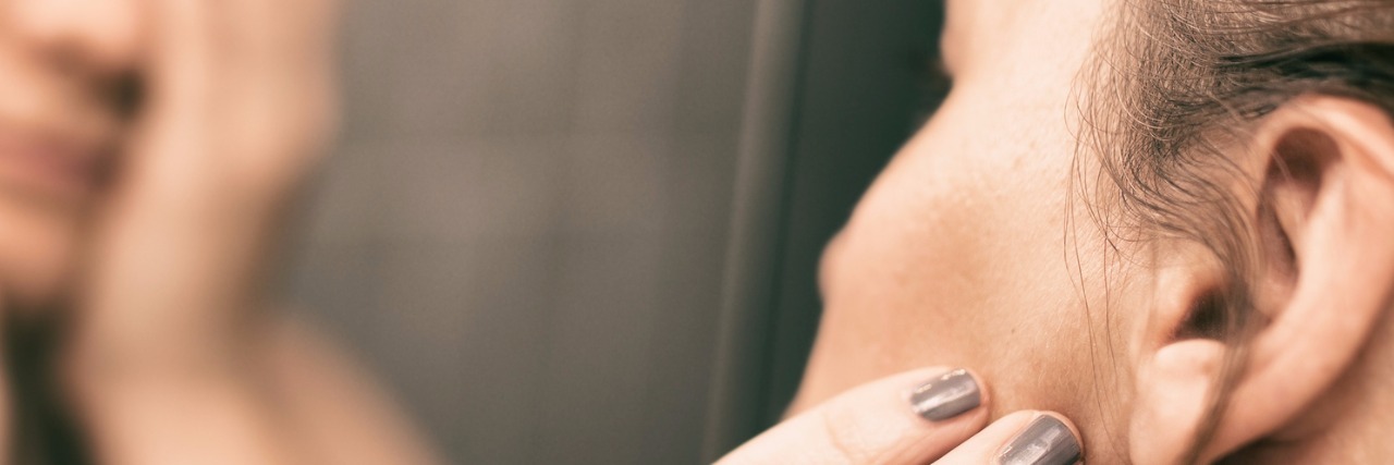 Being Told You Look Good When You Have Chronic Pain woman looking in mirror