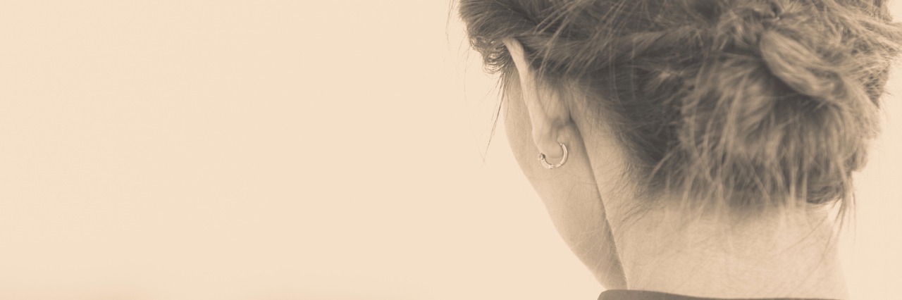 back view of woman's head looking out