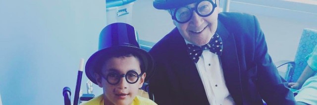 young boy and older man in top hats
