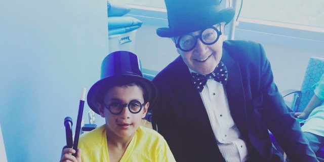young boy and older man in top hats
