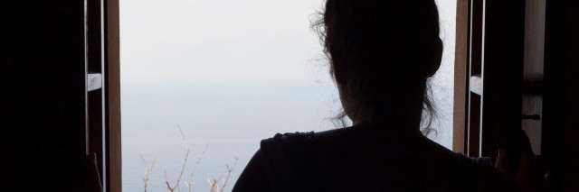 Woman looking through the window