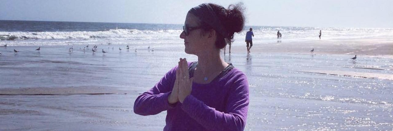Idiopathic Pulmonary Arterial Hypertension and Staying Positive woman doing yoga on the beach