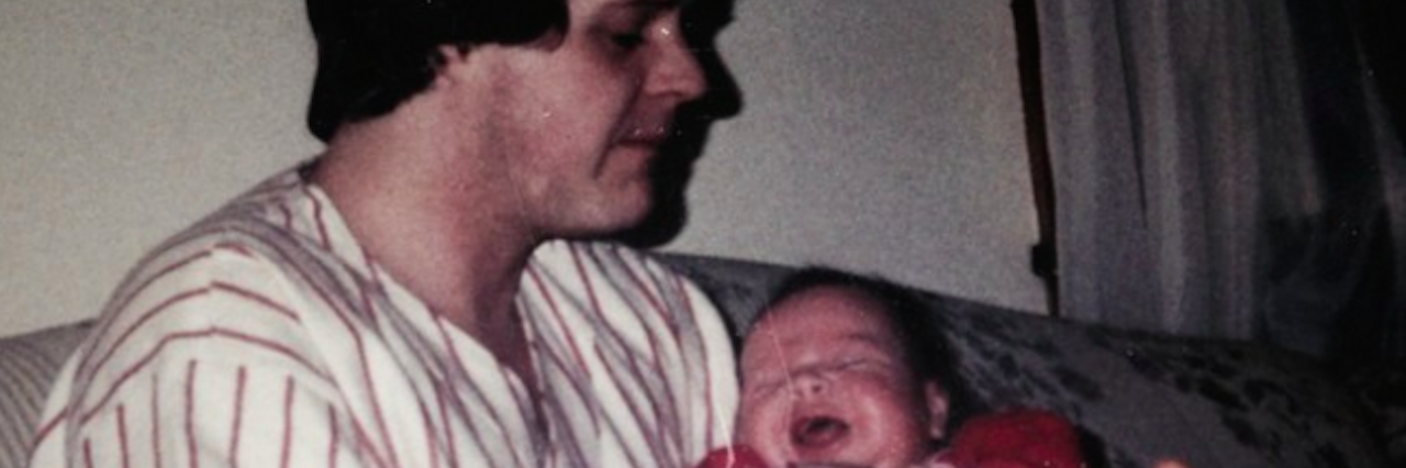 an old photo of the author as a baby and her father