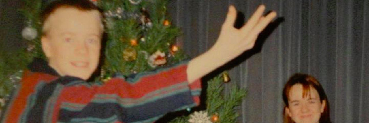 Why I Still Celebrate Christmas After My Brother's Suicide brother and sister around the christmas tree