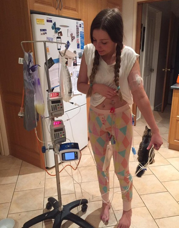 girl standing next to iv pole in kitchen