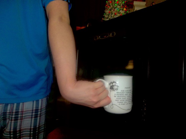 wrist bending the wrong way holding a mug of coffee